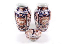 A pair of 19th century Japanese Imari vases and a bowl.