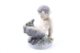 A Royal Copenhagen figure, 'Faun and Frog'. Model no. 1713. H11.