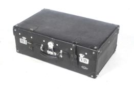 A large black suitcase in the Long March trunk style.