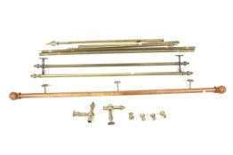 An assortment of curtain poles. Including brass examples and a single turned wooden pole. Max.