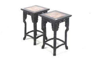 A pair of Chinese hardwood stands with marble inlay tops.
