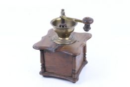 An early to mid-20th century French wooden and brass coffee grinder with drawer.