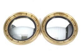 A pair of 20th century convex wall mirrors. Of circular form, with gilt frames.