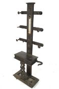 A dark stained oak coat stand.