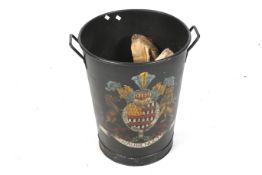 A contemporary metal log bin. With twin handles and decorated with a coat of arms, 'Raubenholt'.