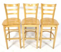 A set of three beech bar chairs.