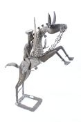 A 20th century African brass horse and rider sculpture.