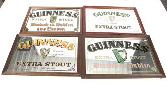 Four large Guinness Extra Stout wall mirrors.