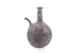 A probably 18th century pilgrim flask with a narrow spout.