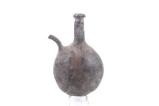 A probably 18th century pilgrim flask with a narrow spout.