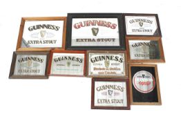 A collection of nine Guinness promotional wall mirrors.