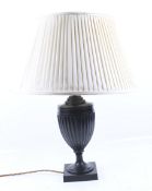 A contemporary bronzed classical urn shaped table lamp. On a square base, with cream shade.