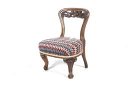 A Victorian walnut over stuffed nursing chair.