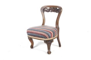 A Victorian walnut over stuffed nursing chair.