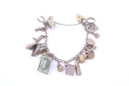 A 9ct gold curb link 'charm' bracelet on a part foliate engraved heart-shaped padlock clasp.