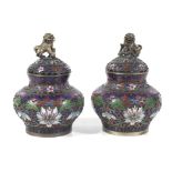 A pair of Chinese champleve and cloisonne enamel lidded vessels.