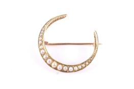 An Edwardian 15ct gold and half-pearl closed-crescent brooch. Hallmarks for Chester 1903, approx.