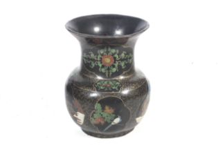 A large black lacquer baluster pot.