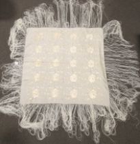 A 20th century cream silk embroidered shawl.