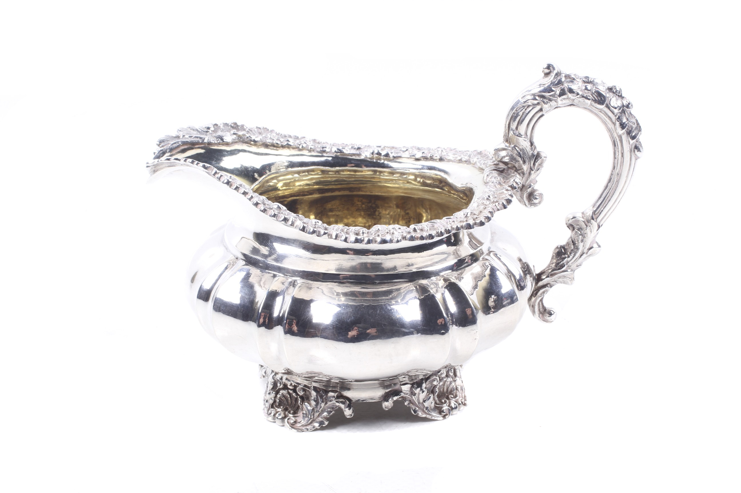 A George IV silver milk jug by Paul Storr Shaped-round or melon-fluted and engraved with a