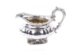 A George IV silver milk jug by Paul Storr Shaped-round or melon-fluted and engraved with a