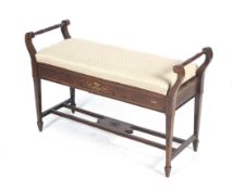 An Edwardian rosewood upholstered duet stool.