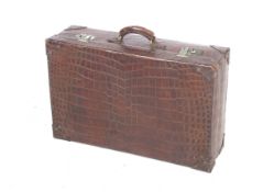 A superb early to mid 20 th century Crocodile skin suitcase with brown linen lining,