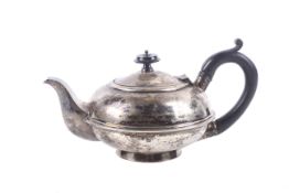 A silver small round teapot.