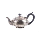 A silver small round teapot.