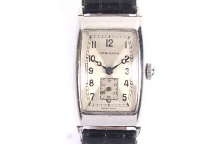Longines, a vintage stainless steel tonneau shaped wrist watch, circa 1938.