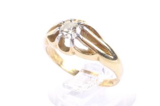 An early/mid 20th century gold and diamond solitaire gypsy ring. The round brilliant diamond approx.