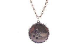 An early 20th century locket and chain.