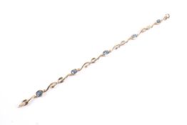 A modern 9ct gold and dark-blue synthetic-spinel bracelet.