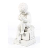 A Parian ware figure of a child writing.