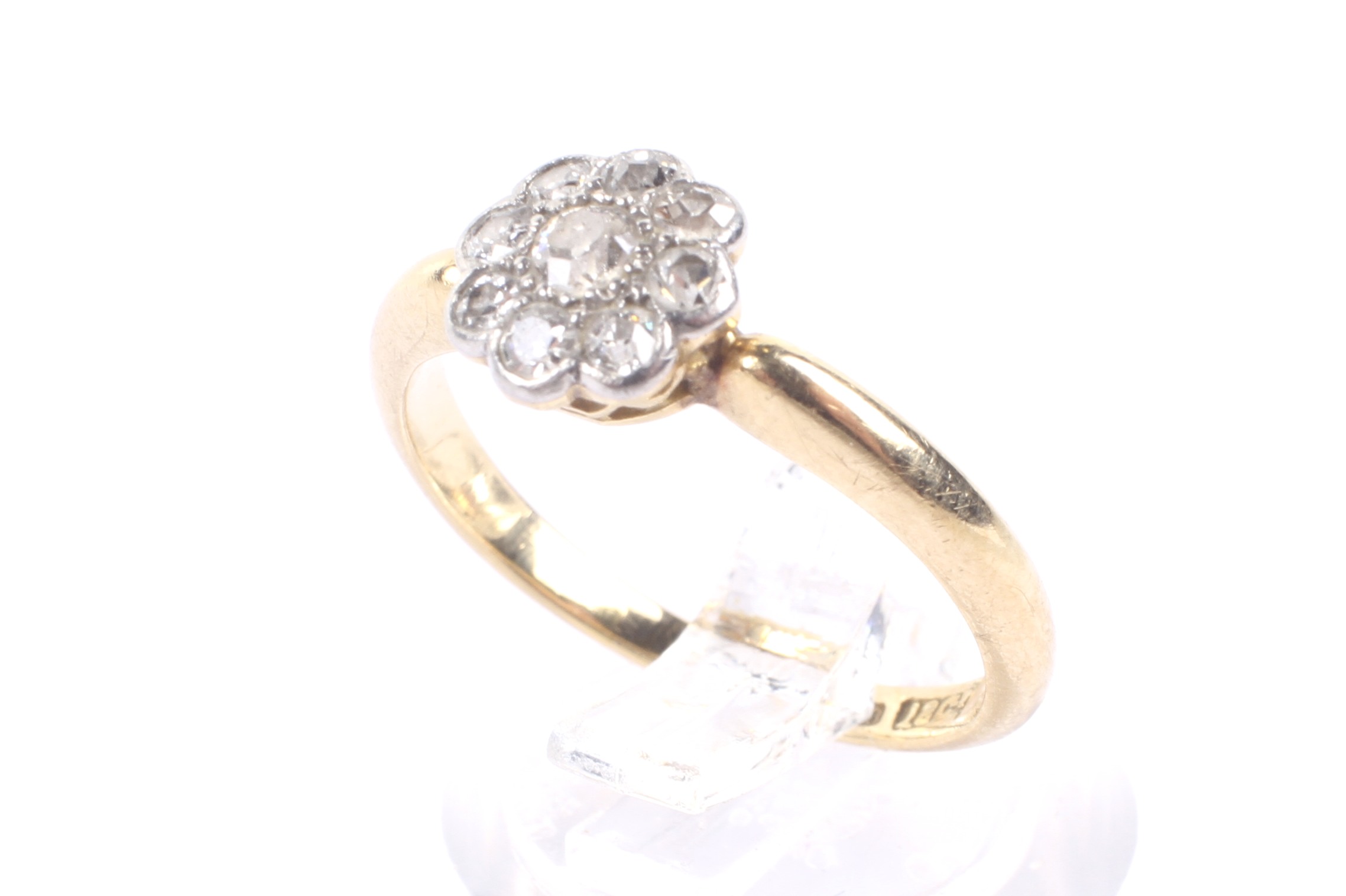 An early 20th century gold and diamond 'daisy' cluster ring, circa 1925.