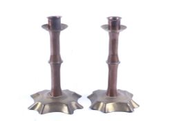 A pair of Arts and Crafts candlesticks in the manner of WAS Benson, circa 1900.