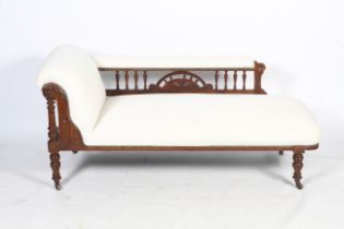 An Edwardian walnut chaise longue.