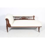 An Edwardian walnut chaise longue.