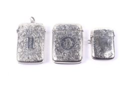 Three silver floral engraved vesta/match cases.