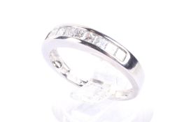 A modern platinum and diamond nine stone half-eternity ring. The nine princess diamonds approx. 0.