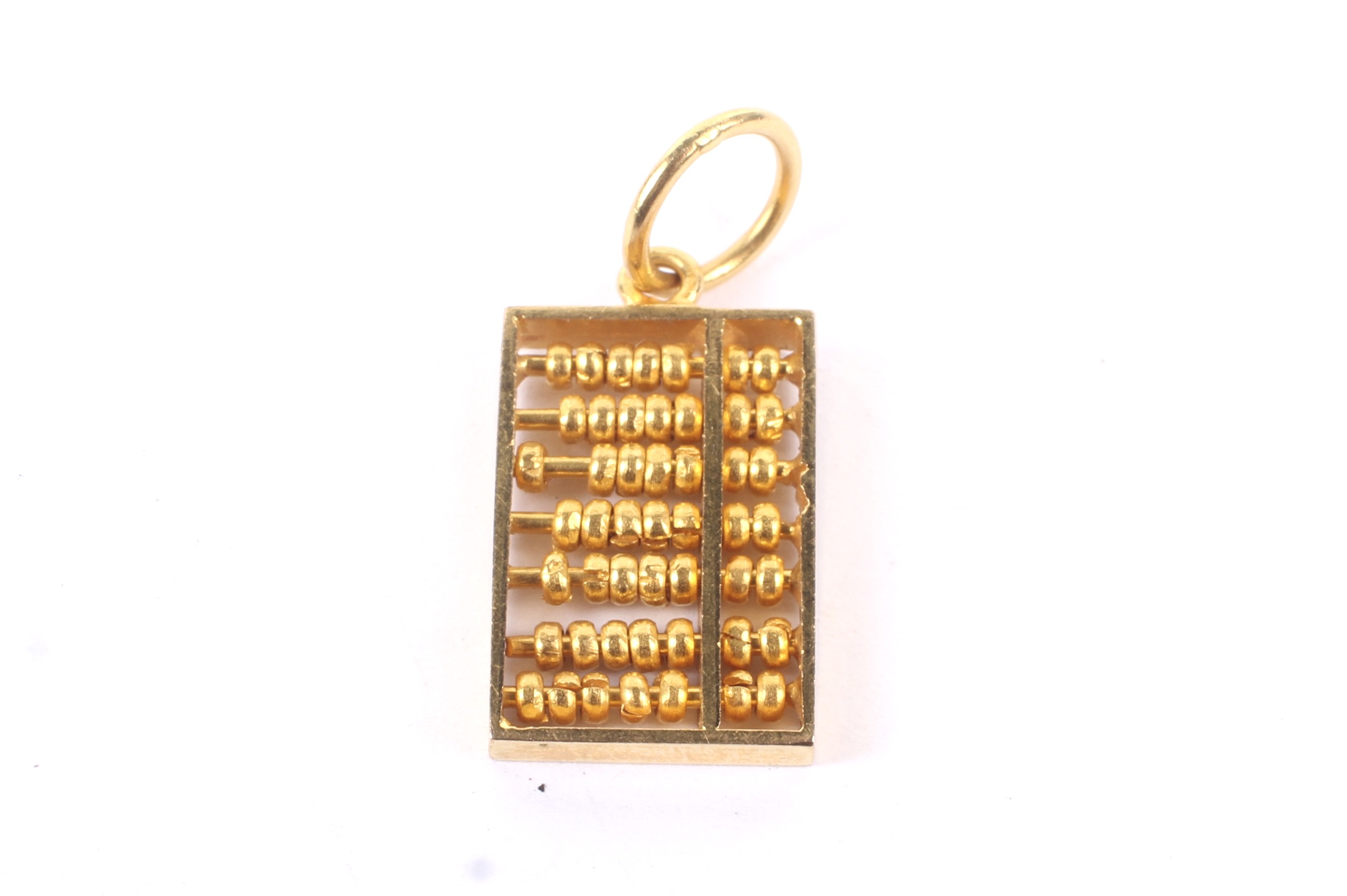 An Asian or middle-eastern high carat 'abacus' charm. Apparently unmarked, approx. 20. - Image 2 of 2