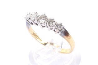 A vintage 18ct gold and diamond five stone ring. The slightly graduated round brilliants approx. 0.