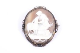 A Victorian gold and oval shell cameo brooch depicting a neo-classical female figure figure.