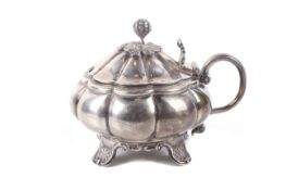 A George IV English provincial silver melon-fluted mustard pot.