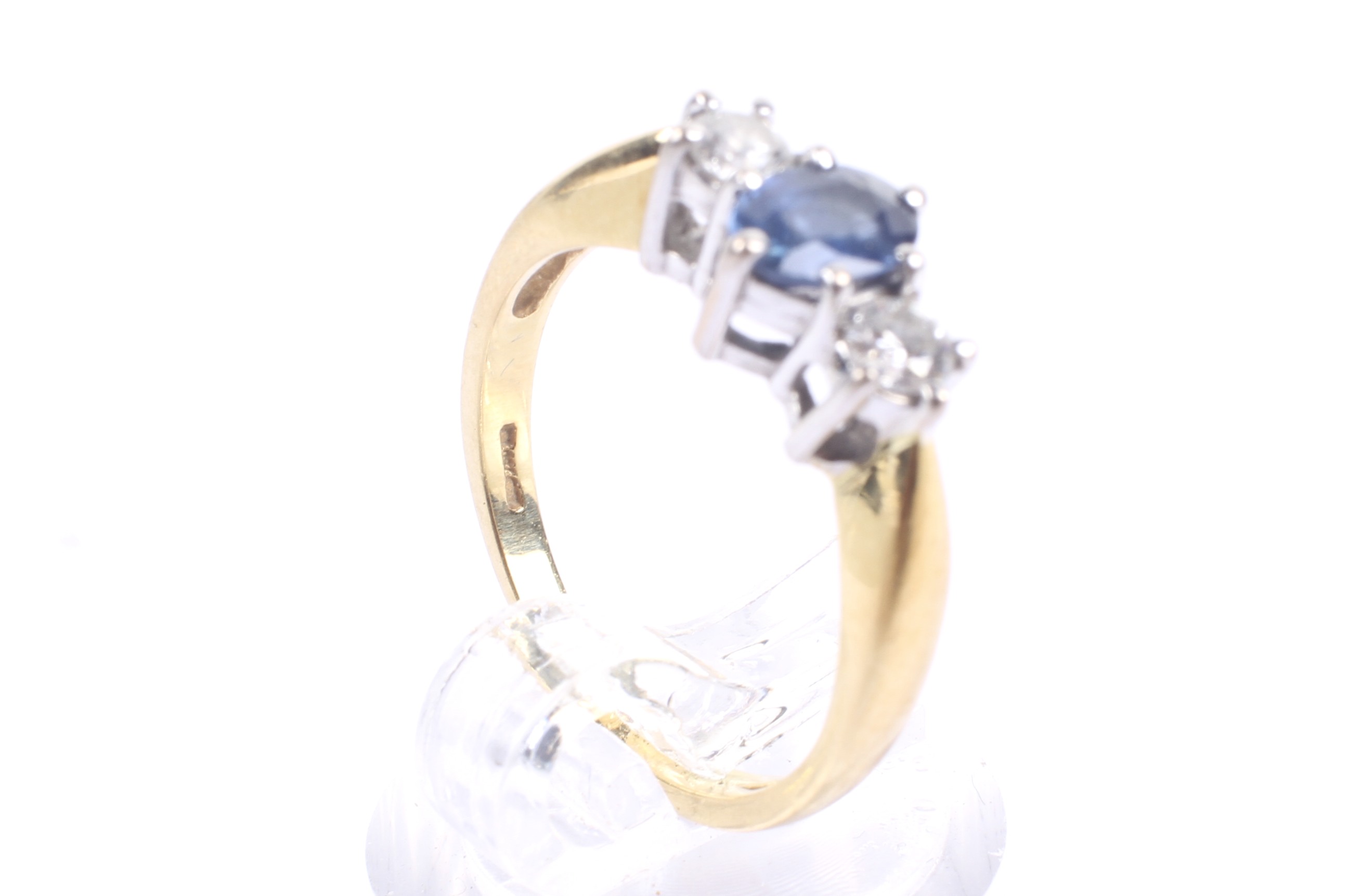 A modern 18ct gold, sapphire and diamond three stone ring. - Image 4 of 4