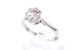 A mid 20th century platinum and diamond solitaire ring. The cushion-shaped old-cut diamond approx.