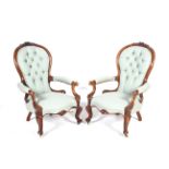 A pair of 19th century spoon-back open armchairs.