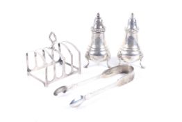 A small collection of silver including a pair of baluster pepper pots in George III style.