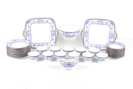 A Wedgwood tea service with blue and white borders of flowers within gilt rims.