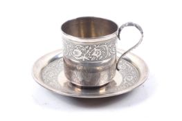 A French silver small cup and saucer.